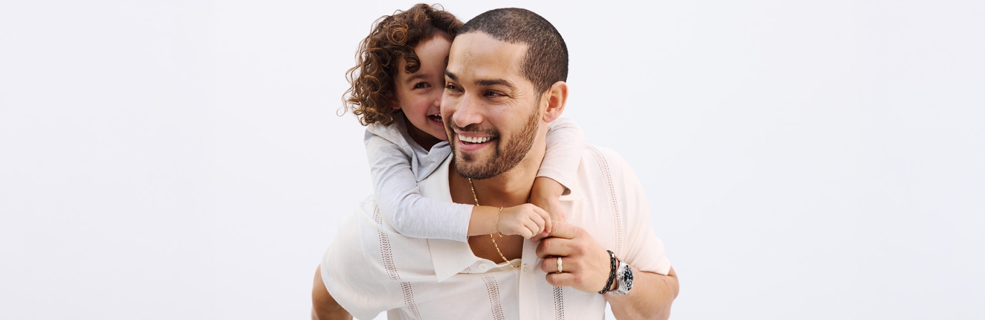 Father celebrating with his child wearing jewelry from Jared