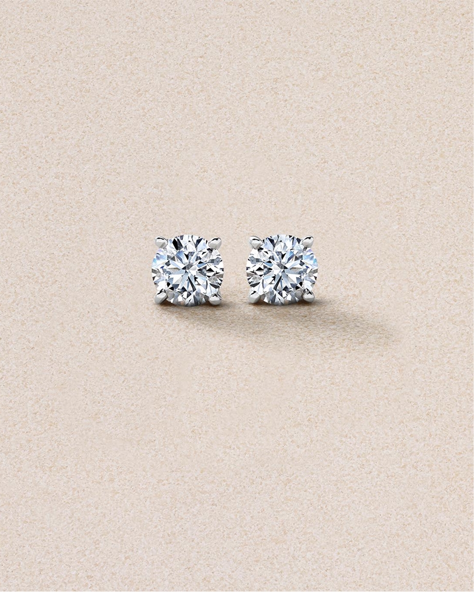 Solitaire diamond earrings set in yellow gold.