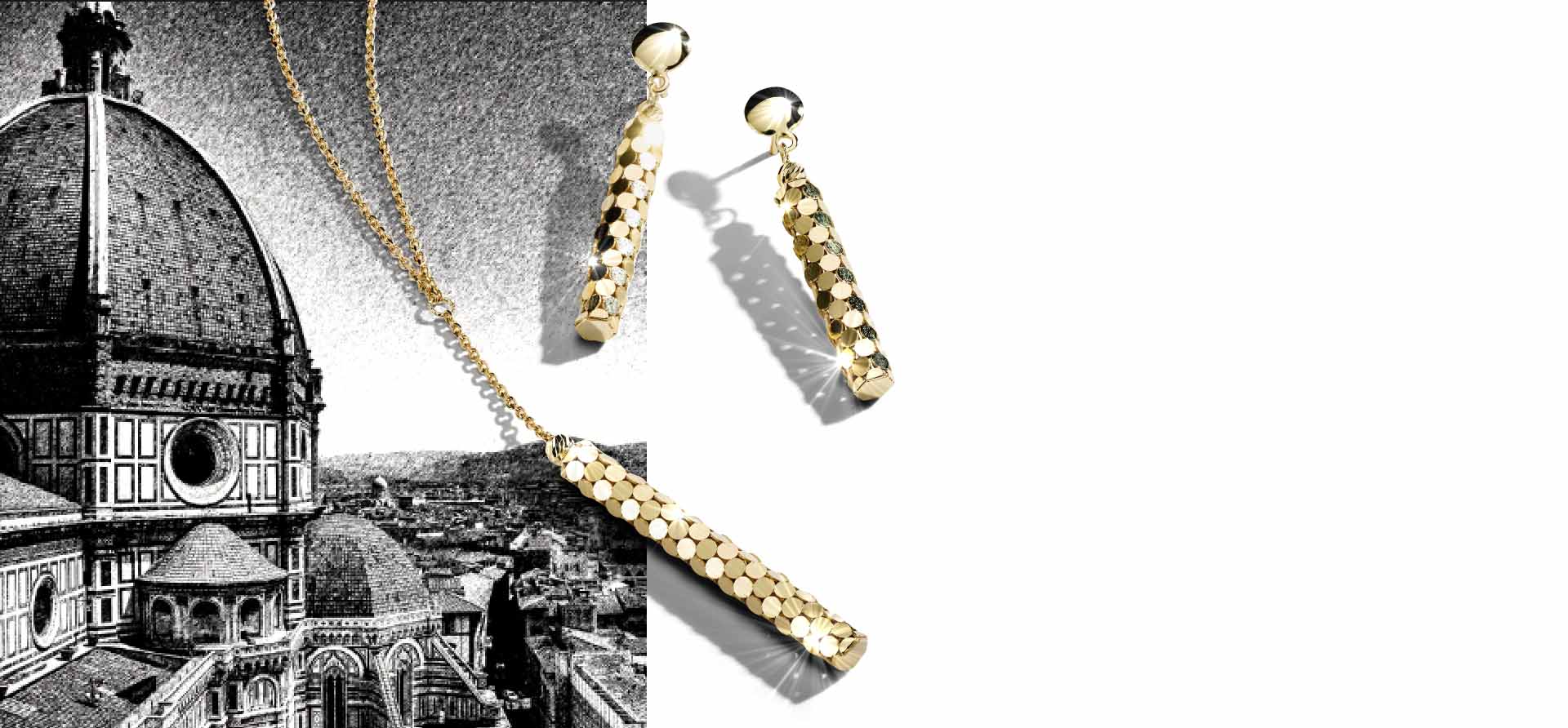 Yellow gold matching yellow gold dangle earrings and pendant on a white background. Shop all Italia D'Oro gold jewelry.