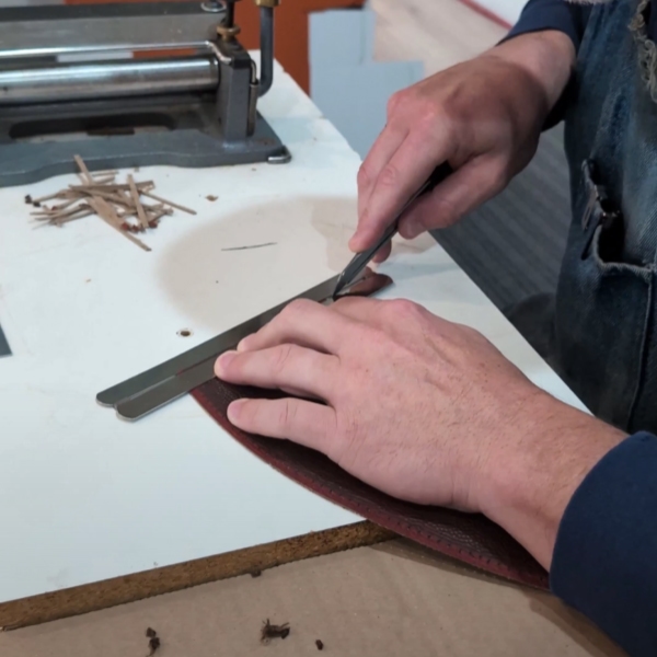 Measuring a piece of the game ball to go inside the Jared Goff ring