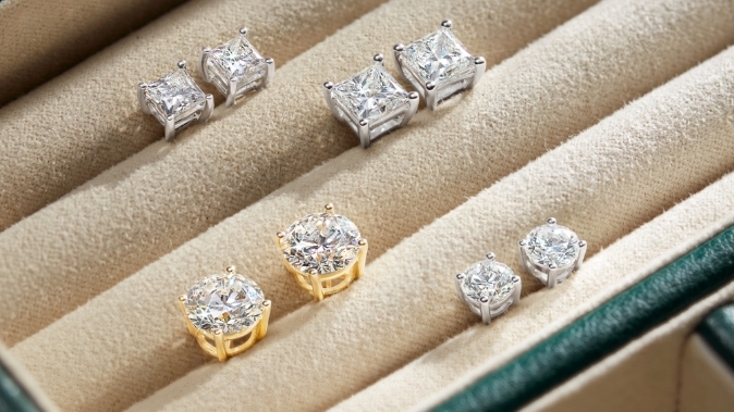 Image of diamond solitaire earrings in a jewelry box.