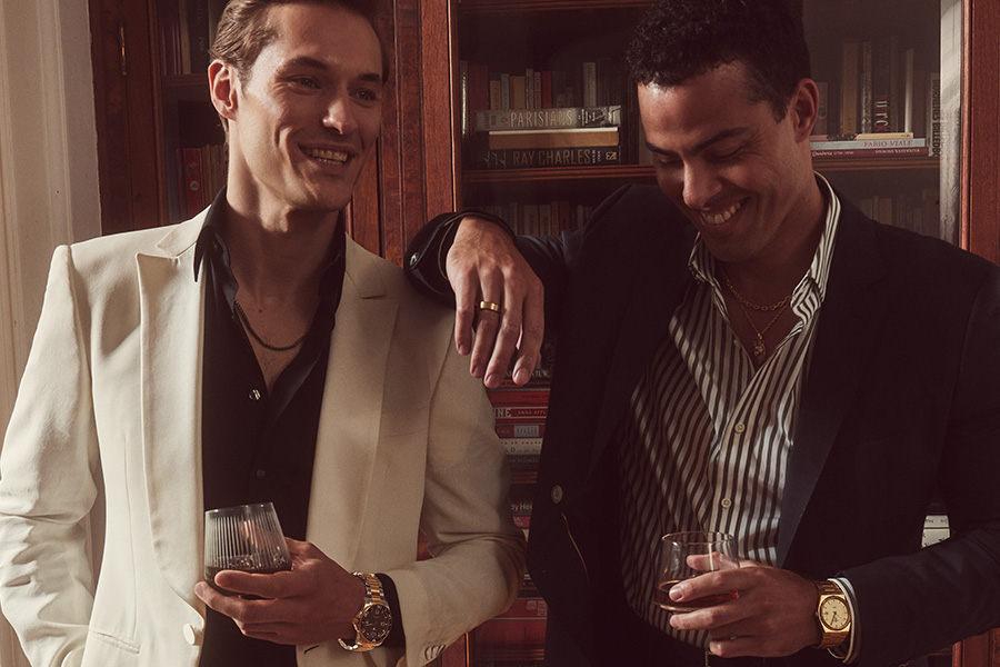 Image of two men wearing fine jewelry.