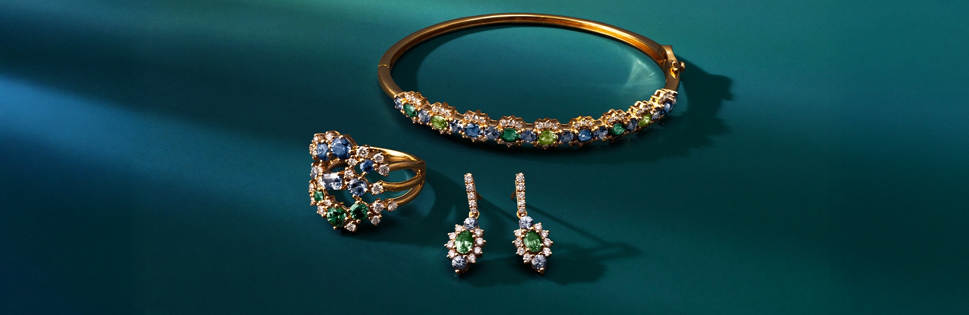 Le Vian Montana Ombre Sapphire jewelry in shades of blue and green, set in 14K yellow gold.