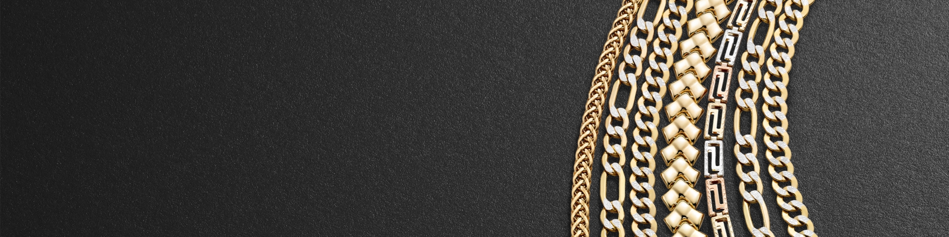 Multiple chain necklace in yellow gold and mixed gold tones in different chain types on a black textured background.