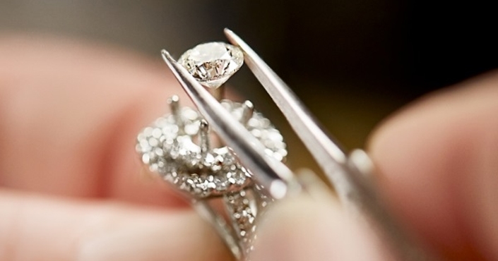 Diamond being set in an engagement ring
