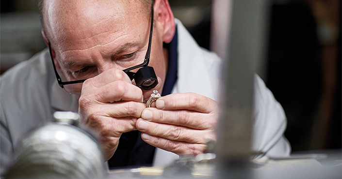 Jared Jewelry Expert examining an engagement ring