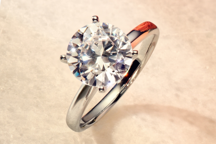 Engagement ring with delicate round diamonds on the halo and band.