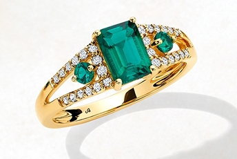 Emerald and diamond engagement ring in yellow gold