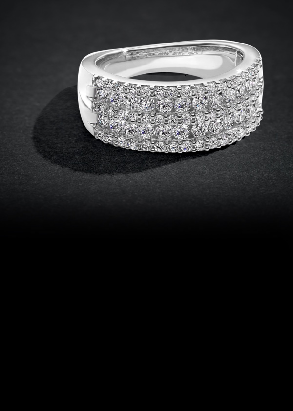 white gold diamond encrusted wedding band on black background