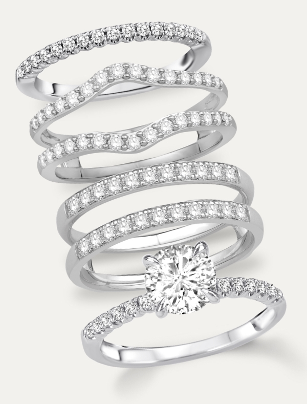 white gold diamond engagement ring and wedding bands against white background