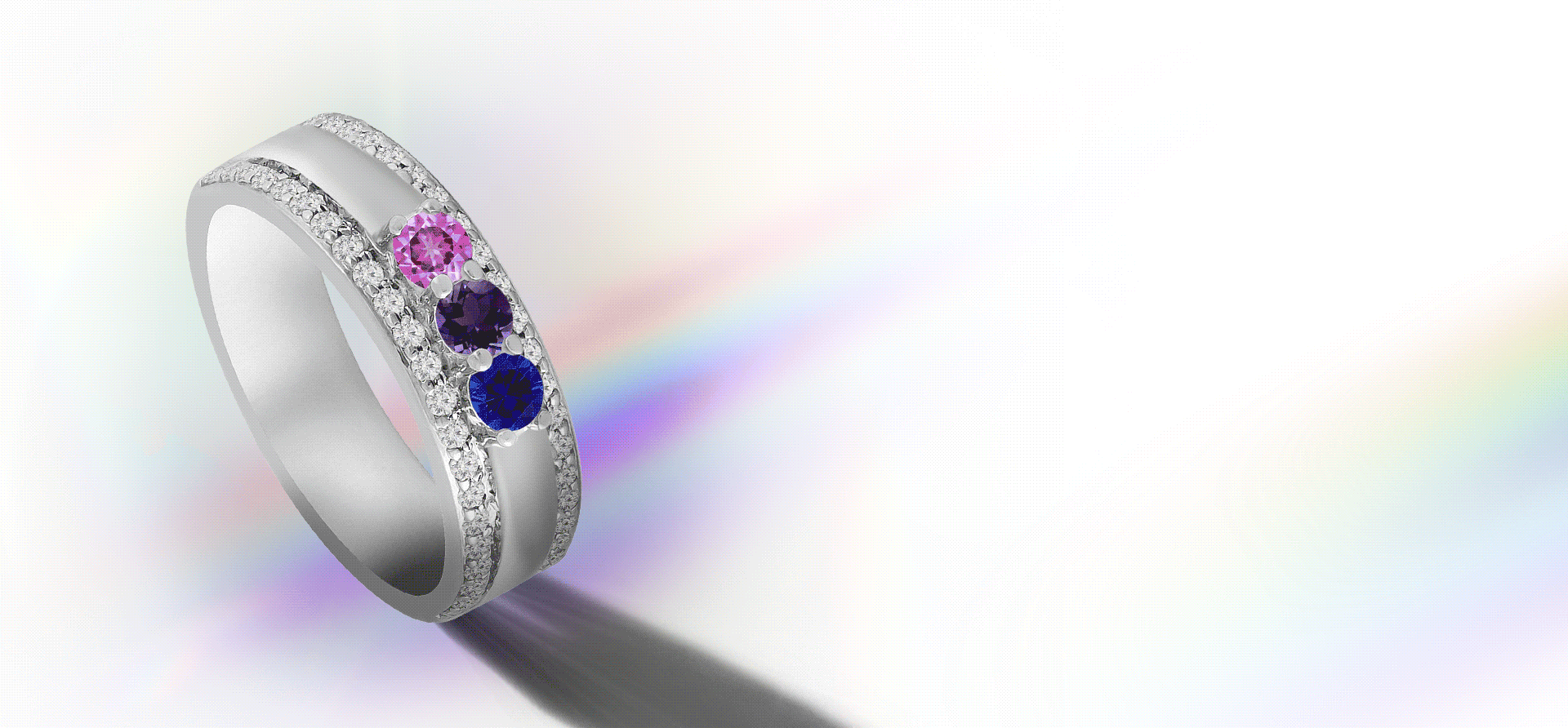 White gold band flashing gemstones in rainbow colors.