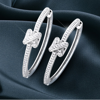 Pair of white gold earrings with white diamonds from the Y Knot Collection