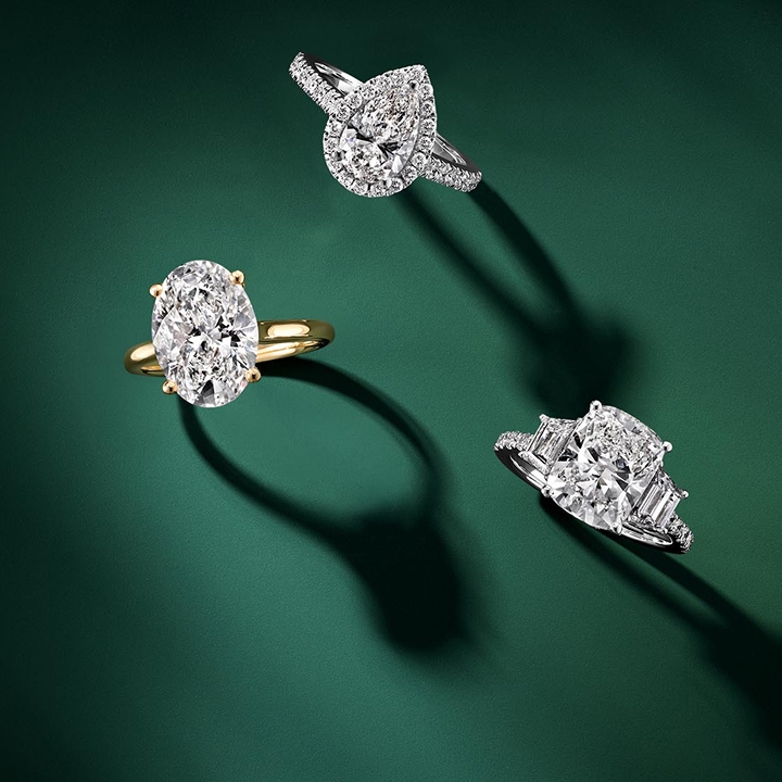 Diamond jewelry statement pieces on a green background