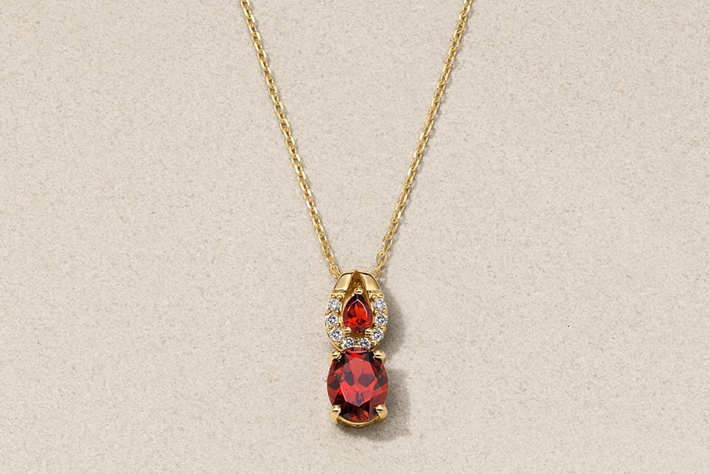 Yellow gold two-stone garnet pendant necklace with diamonds