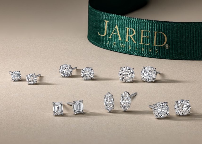 Model wearing silver drop earrings from Jared