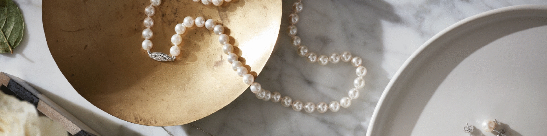 pearl necklace and earrings in bowls, how to take care of jewelry