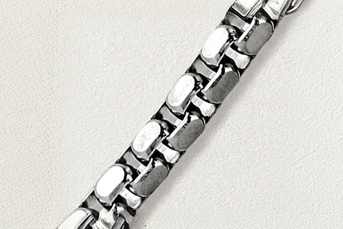 A silver box necklace.