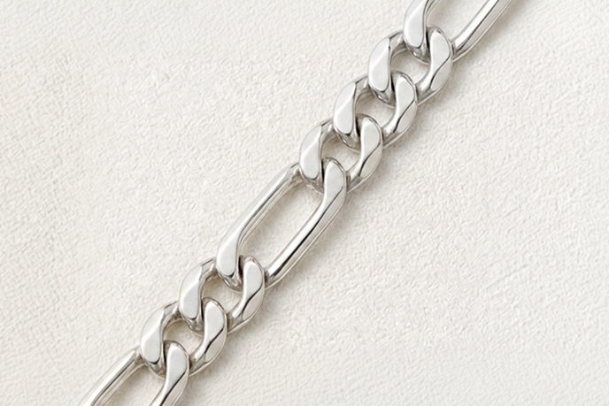 A silver Figaro necklace.