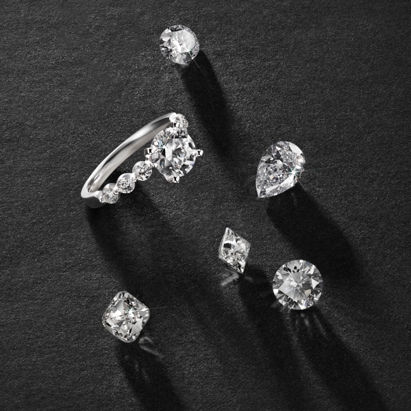 Engagement ring next to many loose diamonds