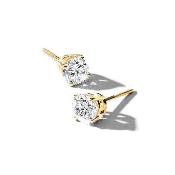 Solitaire diamond earrings set in yellow gold.