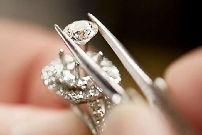 Diamond being set in an engagement ring