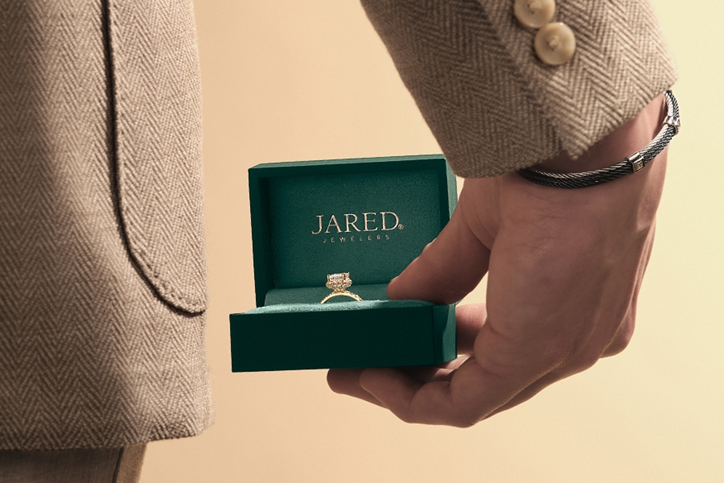 Image of a man holding an Engagement Ring from Jared