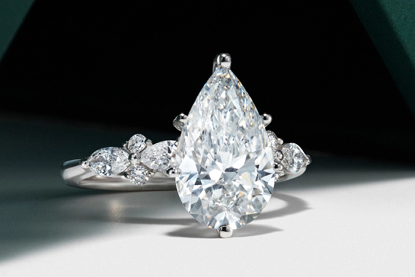 White gold engagement ring with pear shaped center diamond