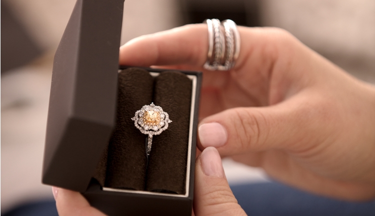 yellow diamond ring in vintage setting being held in a box