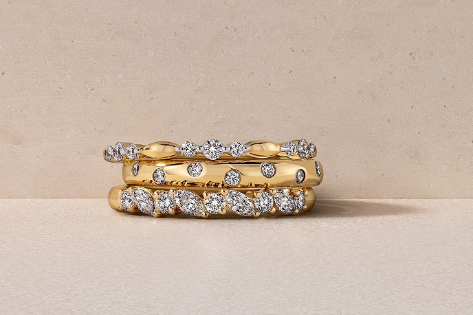 three stacked gold and diamond wedding bands