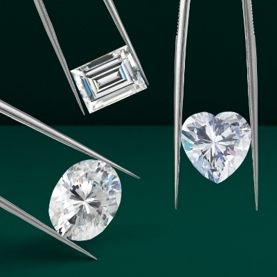 Image of three loose diamonds in emerald cut, oval cut, and heart cut shapes.