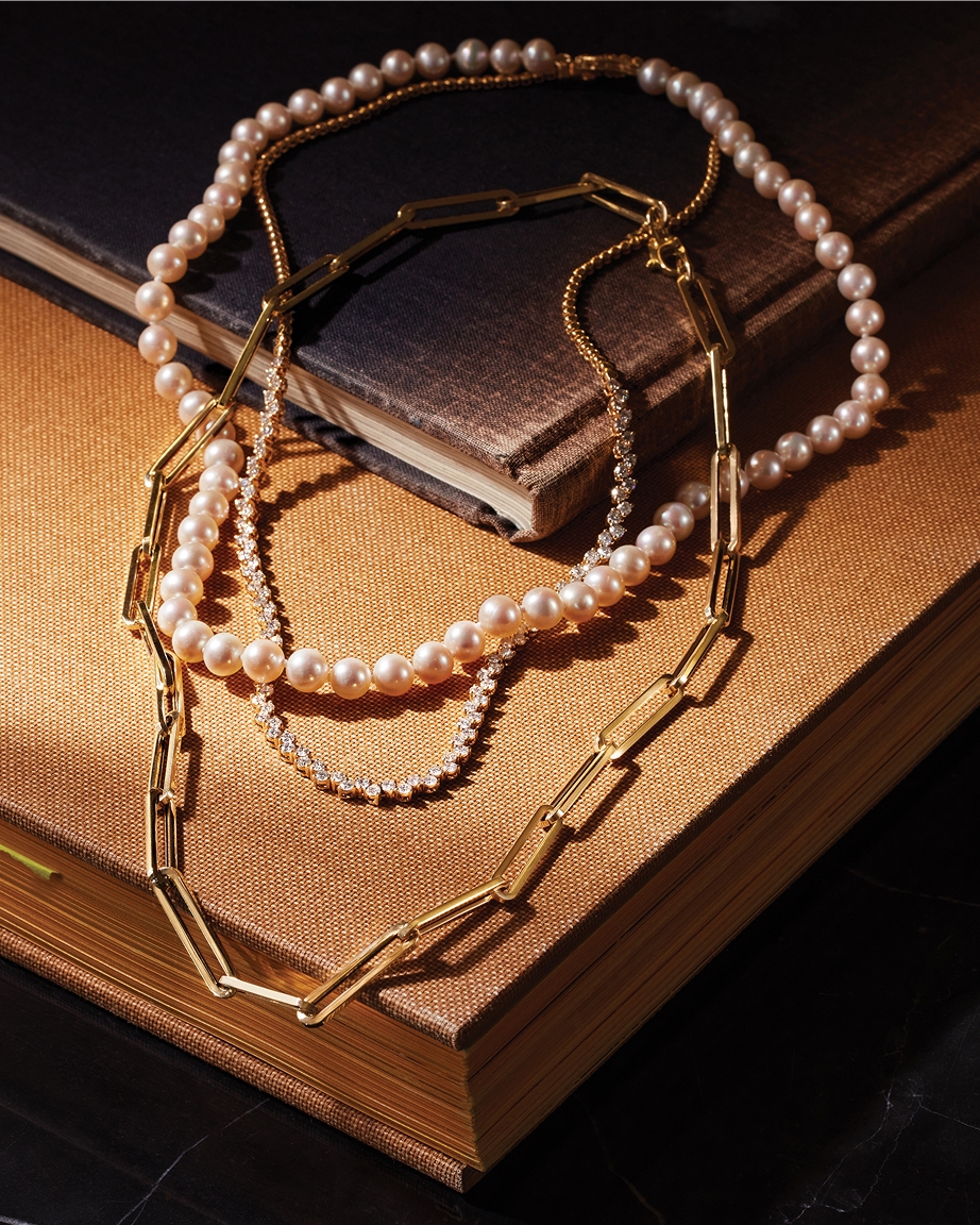 Shop layering cultured pearl strands and gold chains