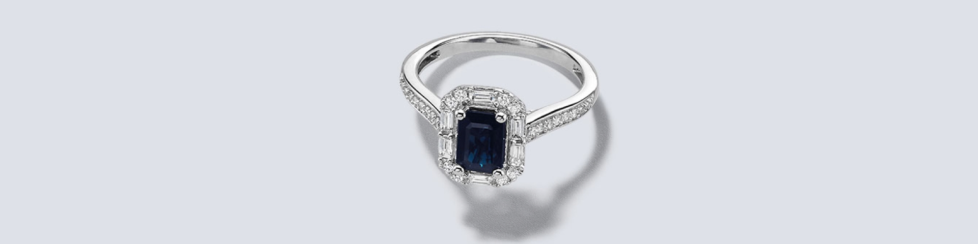 Sapphire engagement ring on a grey background