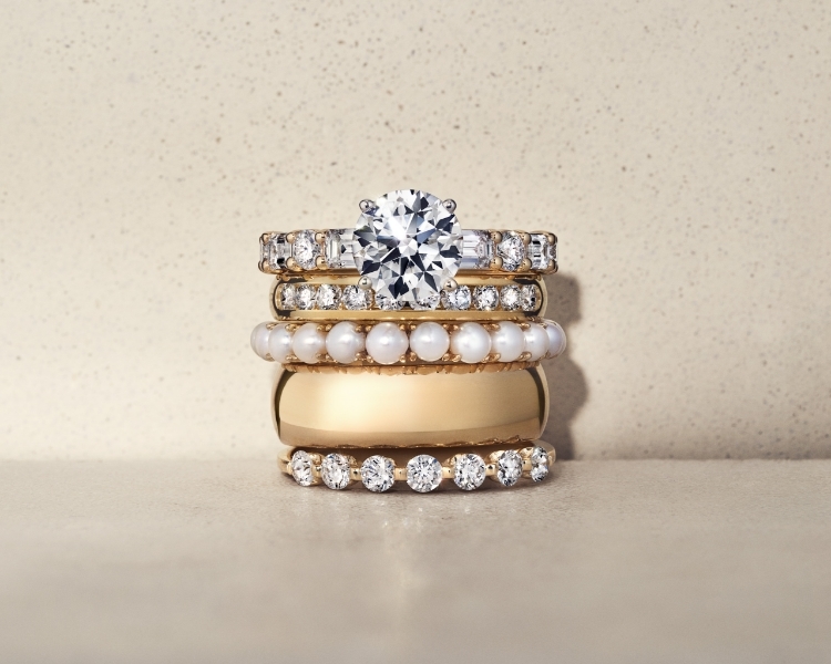 Yellow gold bands and engagement ring stacked