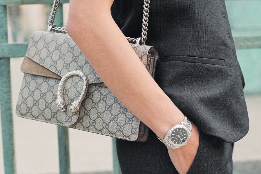 Model wearing a REKLAIM handbag and watch