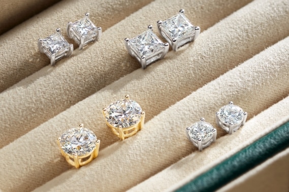 Image of diamond solitaire earrings in a jewelry box.