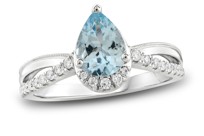 White gold ring with pear shaped aquamarine center stone.