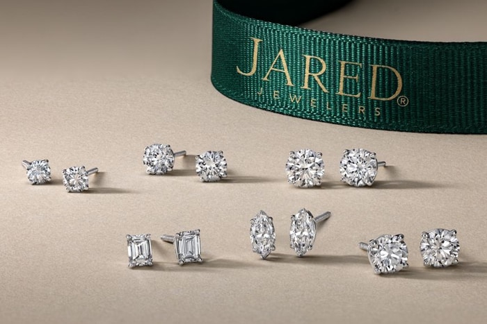 Model wearing silver drop earrings from Jared
