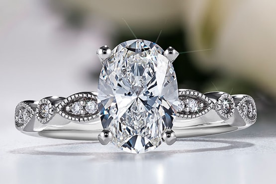 Oval engagement ring with milgrain band