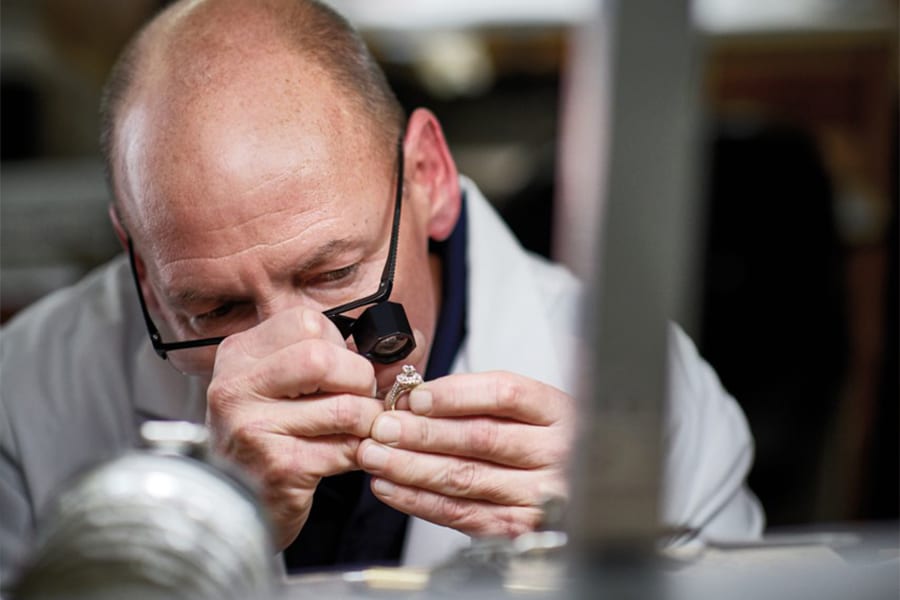 Jeweler inspecting a ring for repair