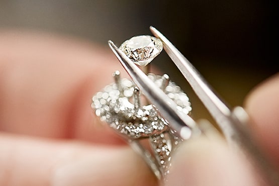 image of jeweler examining loose diamond