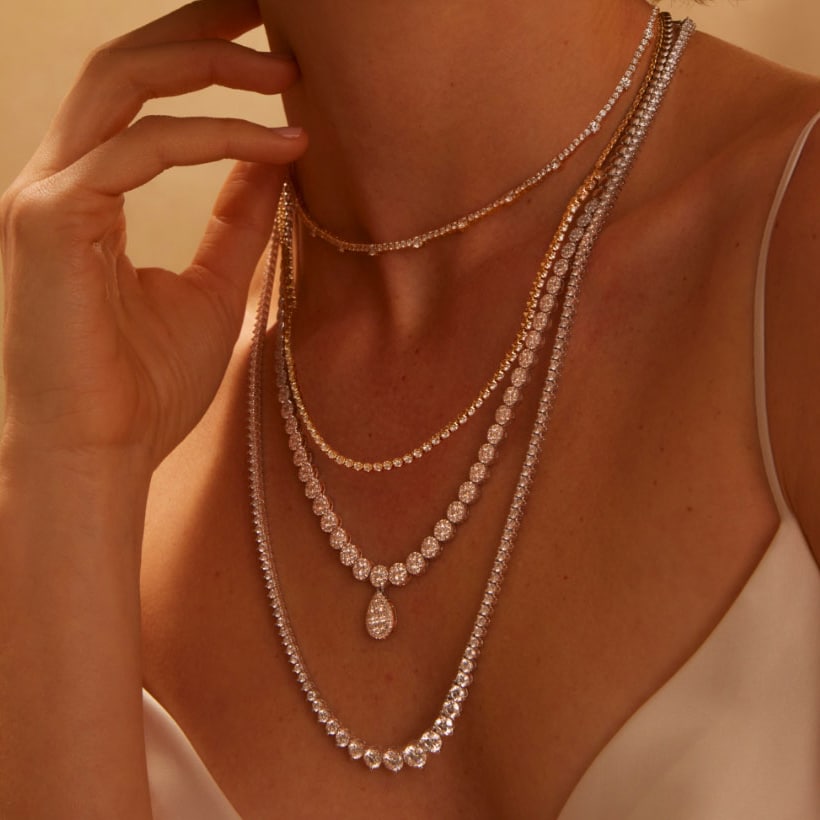 Image of woman wearing multiple diamond necklaces.