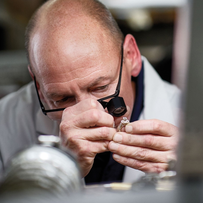 Expert jeweler inspecting a ring