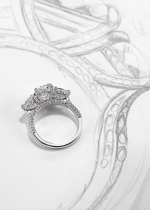 Engagement ring laying on a sketch of a ring