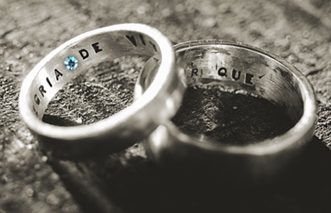 Two rings with engraving on the inside of the band one blue gemstone